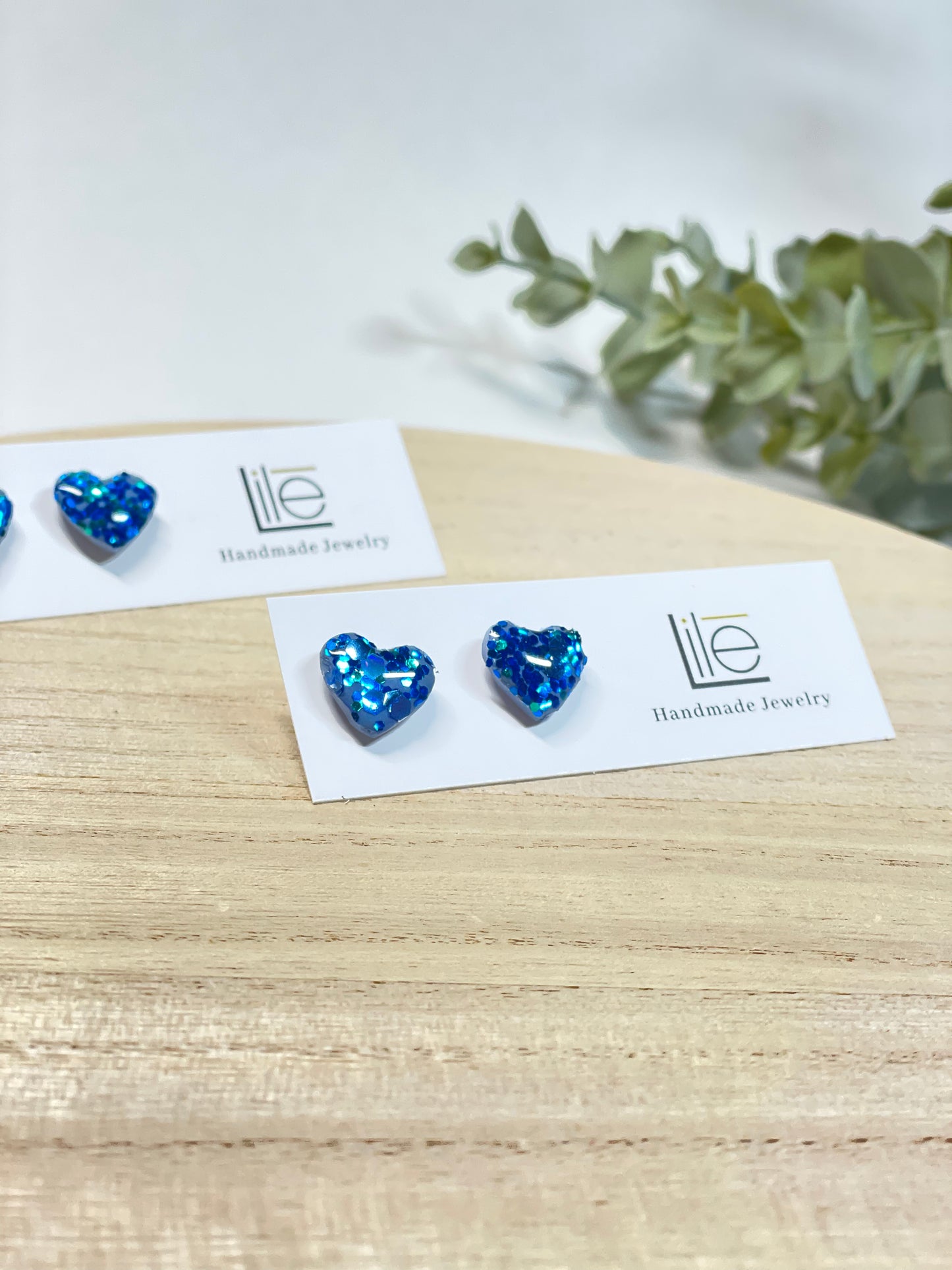 Blue glitter heart studs